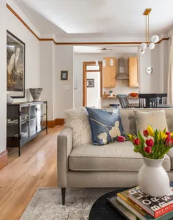 a living room with furniture and a chandelier