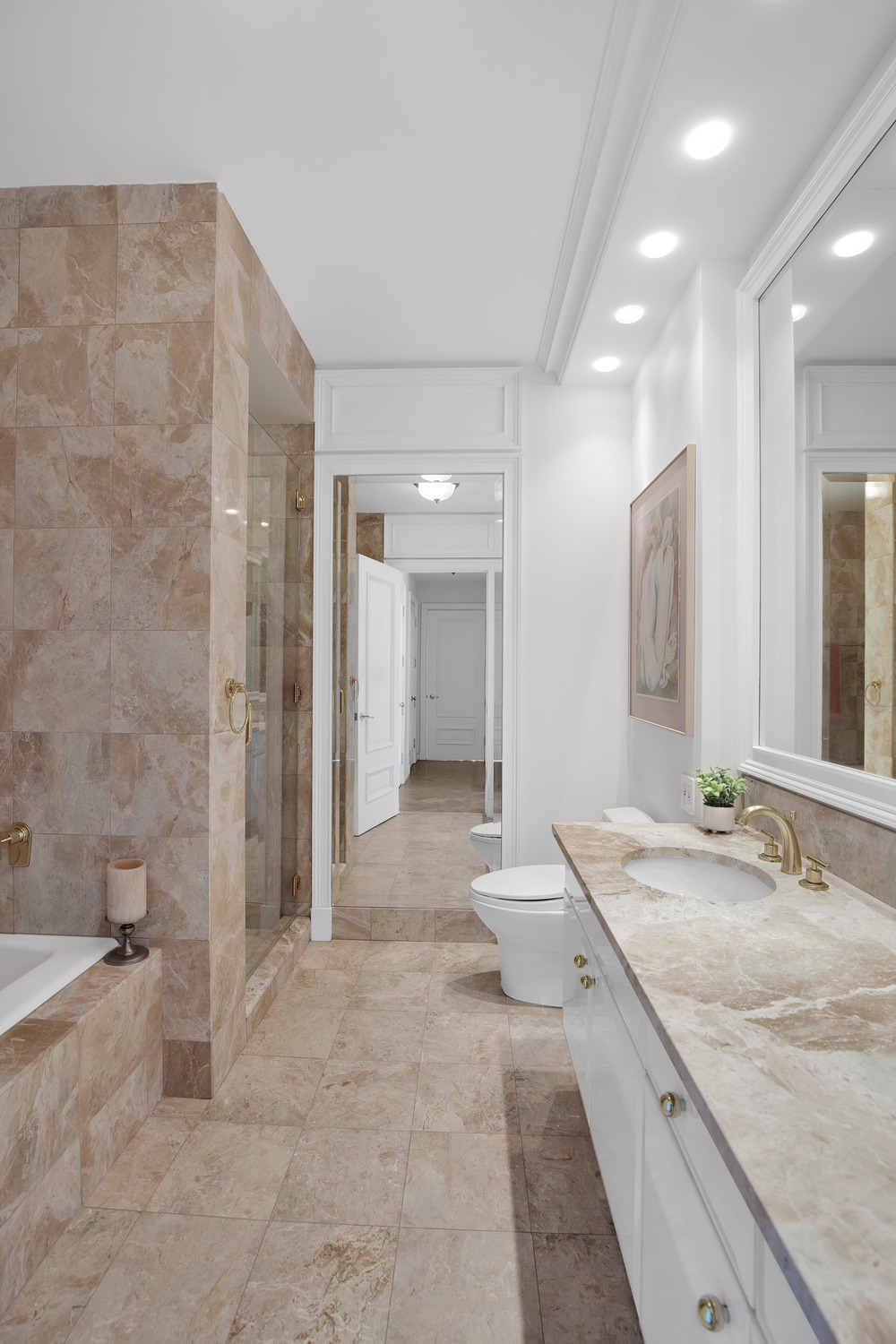 200 Riverside Boulevard, Unit 44A Manhattan, NY 10069 - Photo 11 of 22 a spacious bathroom with a granite countertop sink a mirror and a bathtub