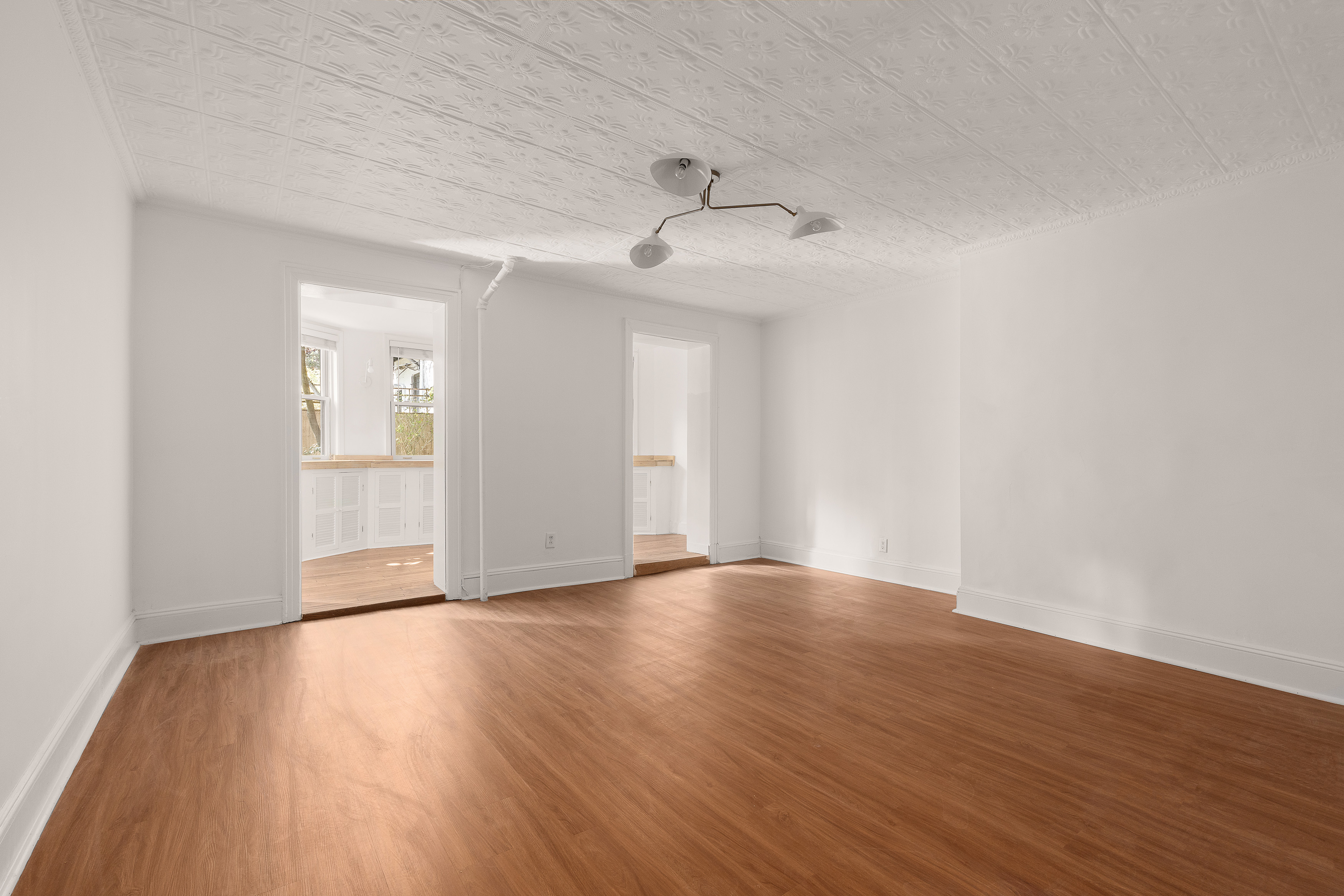 176 Warren Street, Unit GARDEN Brooklyn, NY 11201 - Photo 2 of 9 a view of an empty room with wooden floor and a ceiling fan