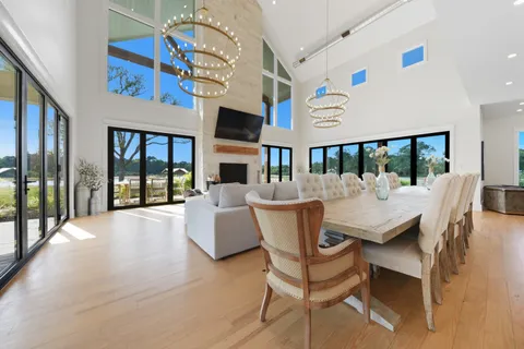 a spacious bathroom with a granite countertop sink a mirror a vanity and a shower