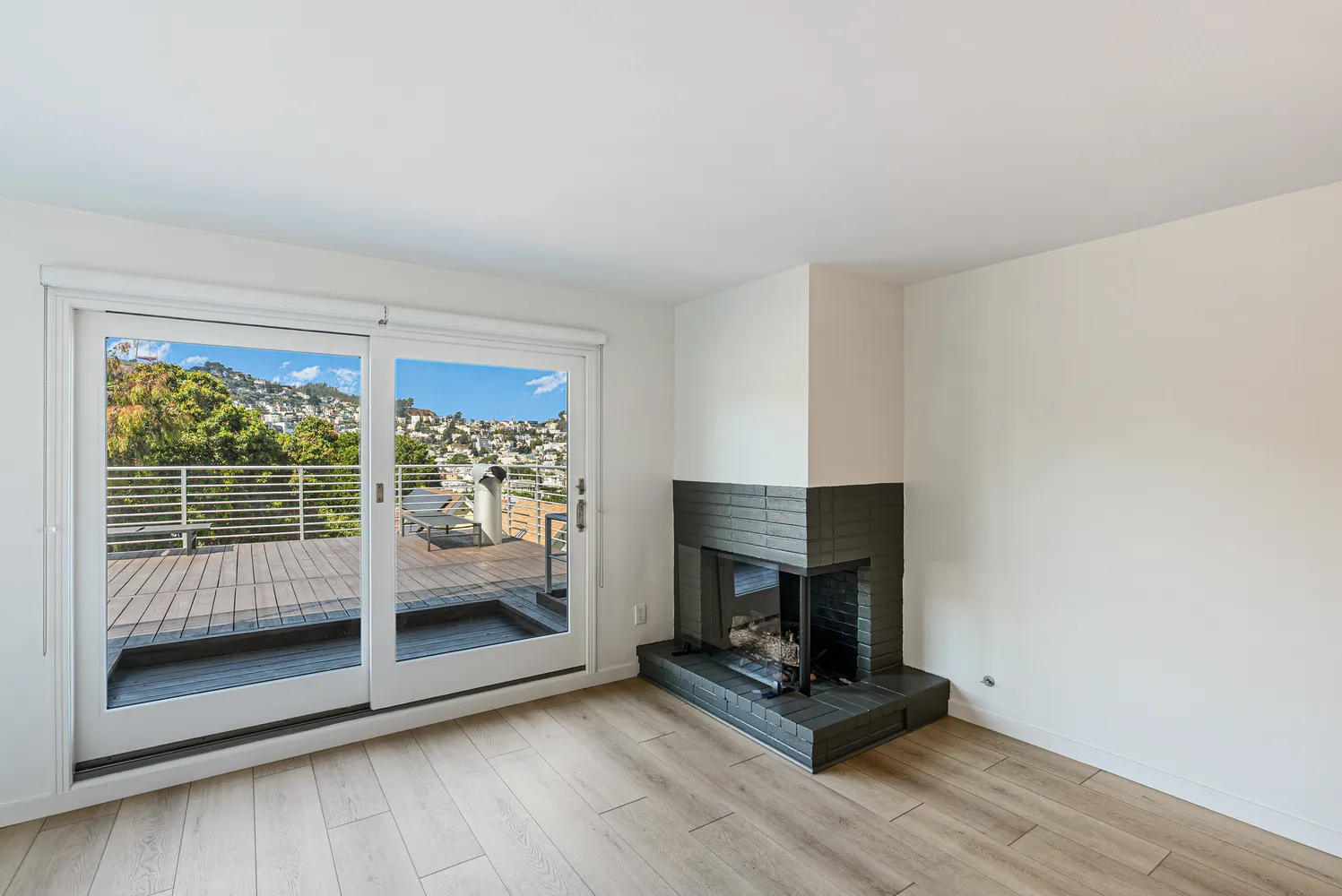 a living room with hardwood floor and a fireplace