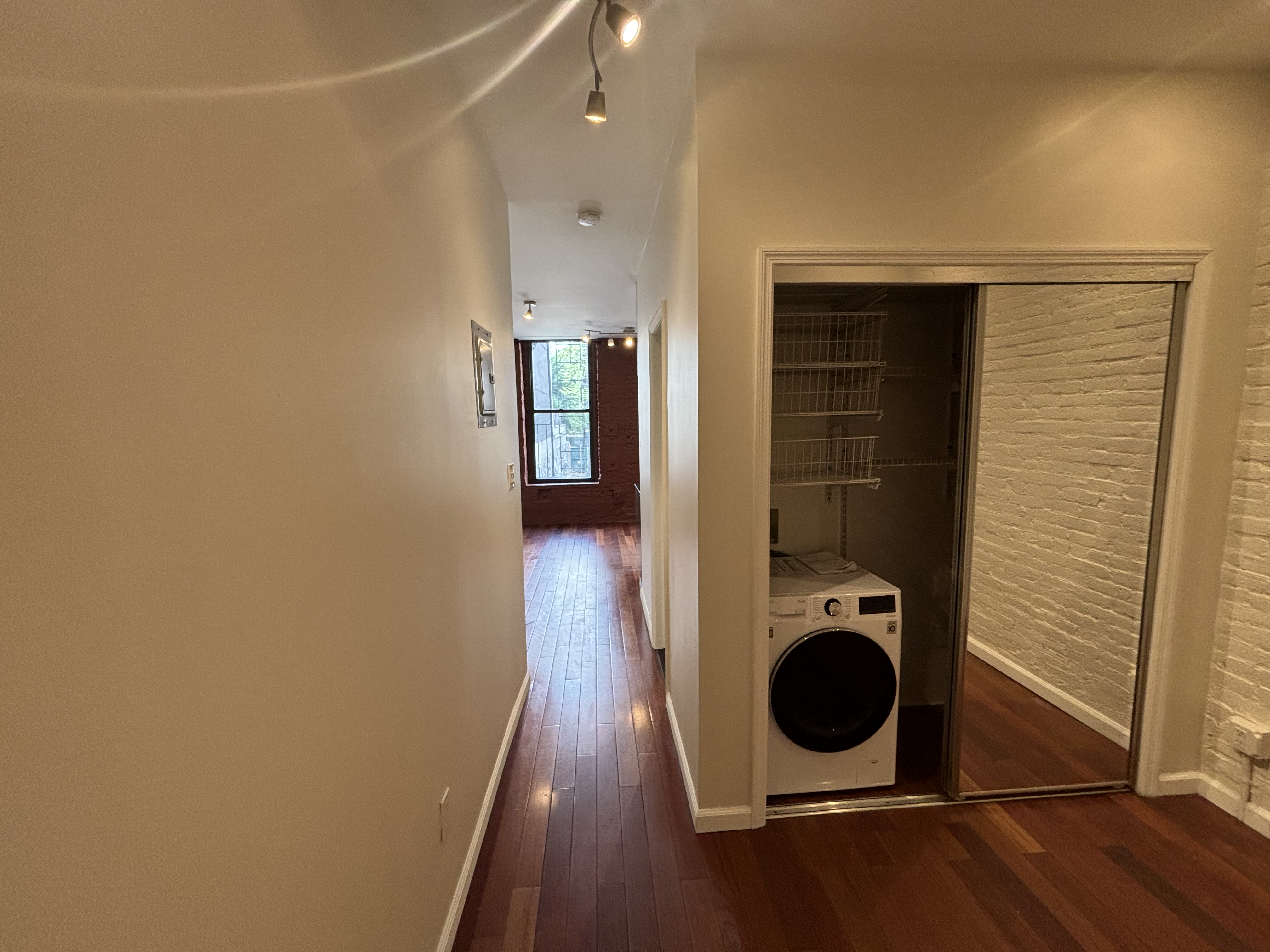 157 Rivington Street, Unit 4 Manhattan, NY 10002 - Photo 2 of 3 an entryway and a hallway with wooden floor