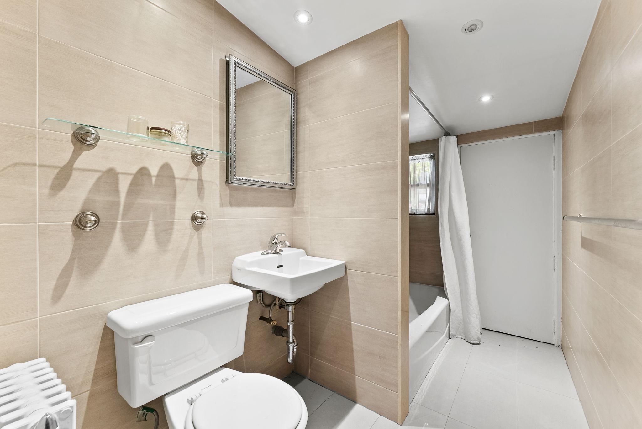 318 11th Street, Unit 1R Brooklyn, NY 11215 - Photo 5 of 7 a bathroom with a toilet sink and shower