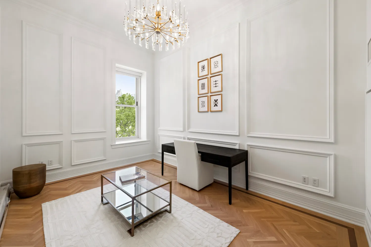 a dining room with wooden floor and chandelier