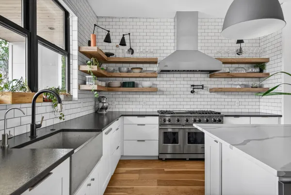 a kitchen with stainless steel appliances granite countertop a stove and a sink