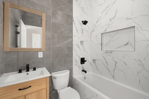 a bathroom with a sink toilet and shower