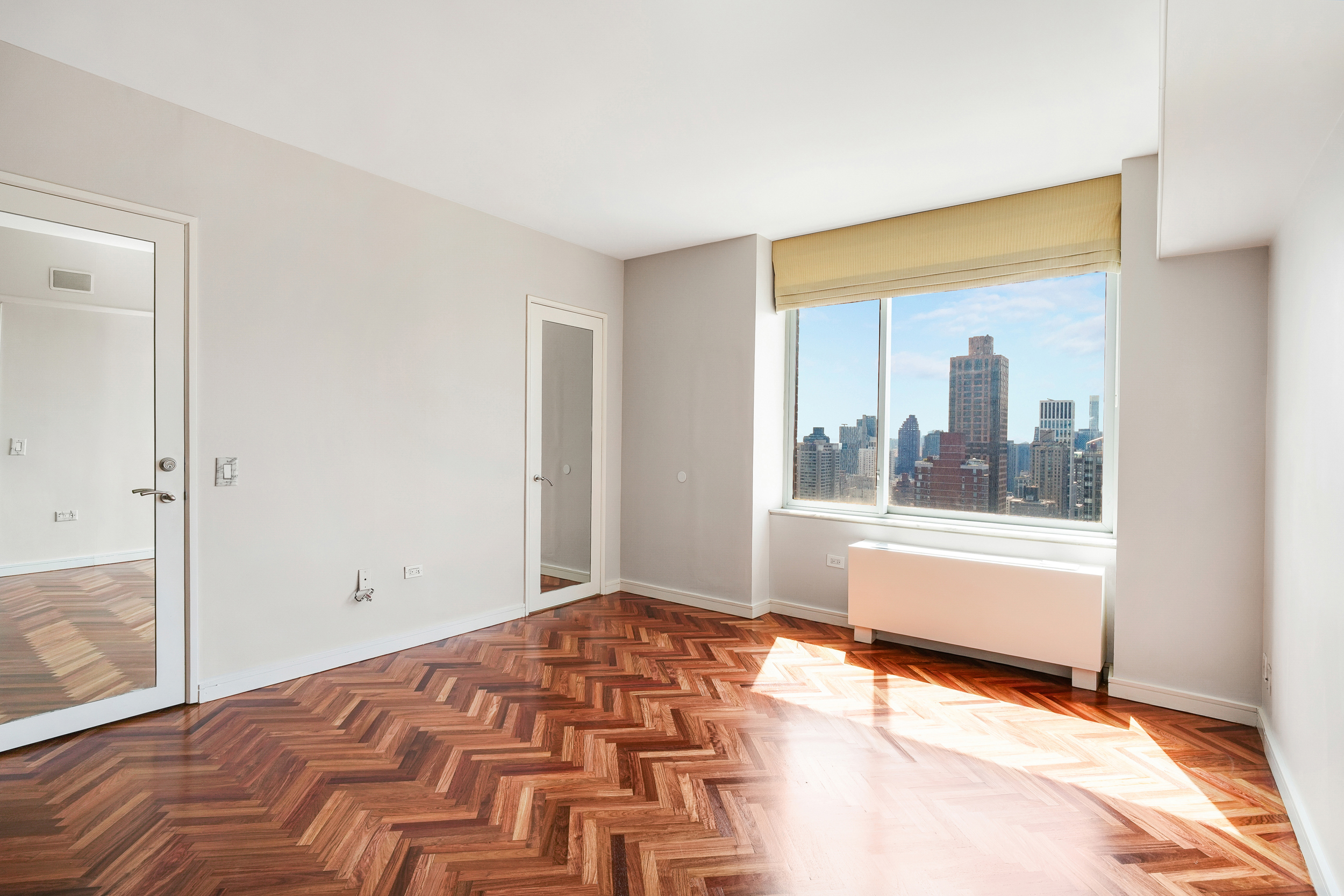 360 East 88th Street, Unit 34A Manhattan, NY 10128 - Photo 17 of 35 a bedroom with a bed and a window