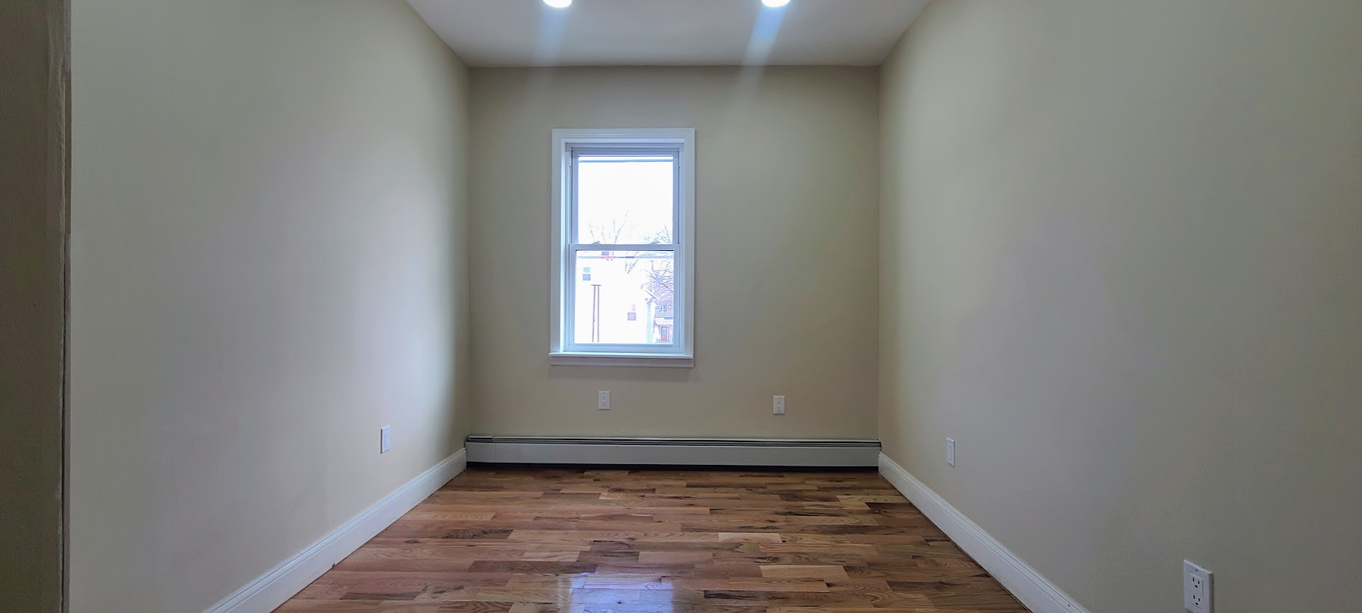 97-08 Plattwood Avenue, Unit 2 Queens, NY 11417 - Photo 8 of 10 a view of an empty room and window