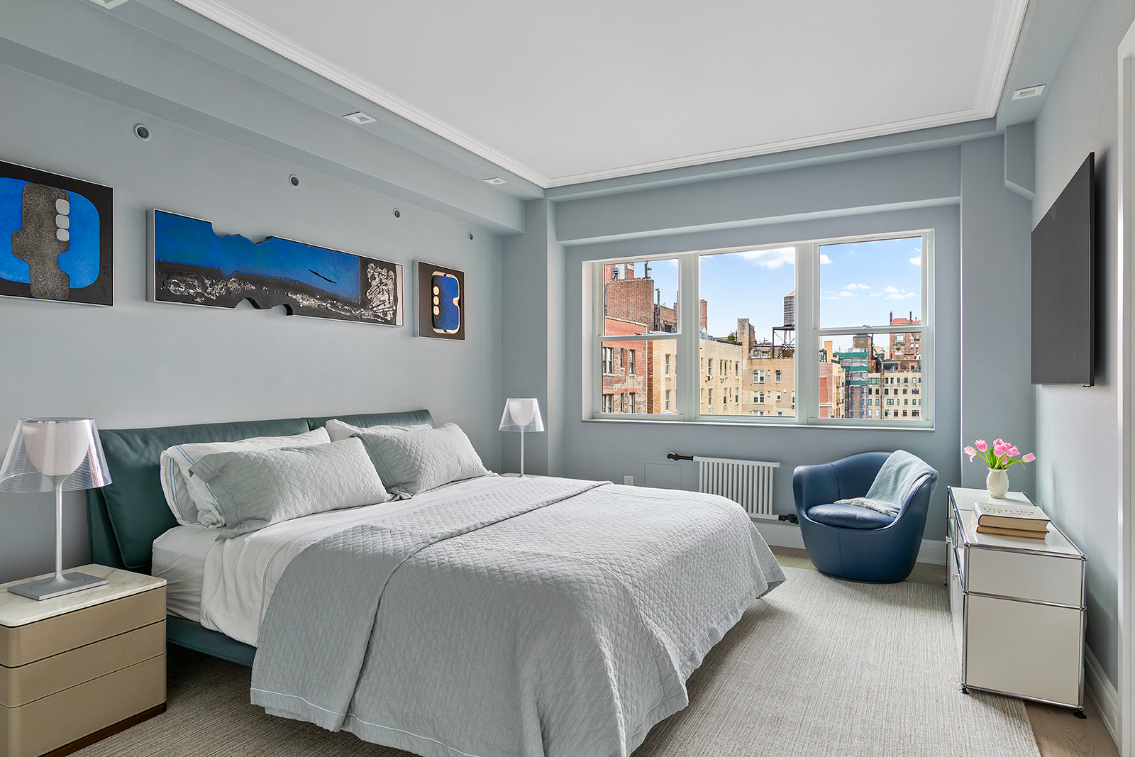 165 East 72nd Street, Unit 17L Manhattan, NY 10021 - Photo 9 of 12 a bedroom with a bed and a large window