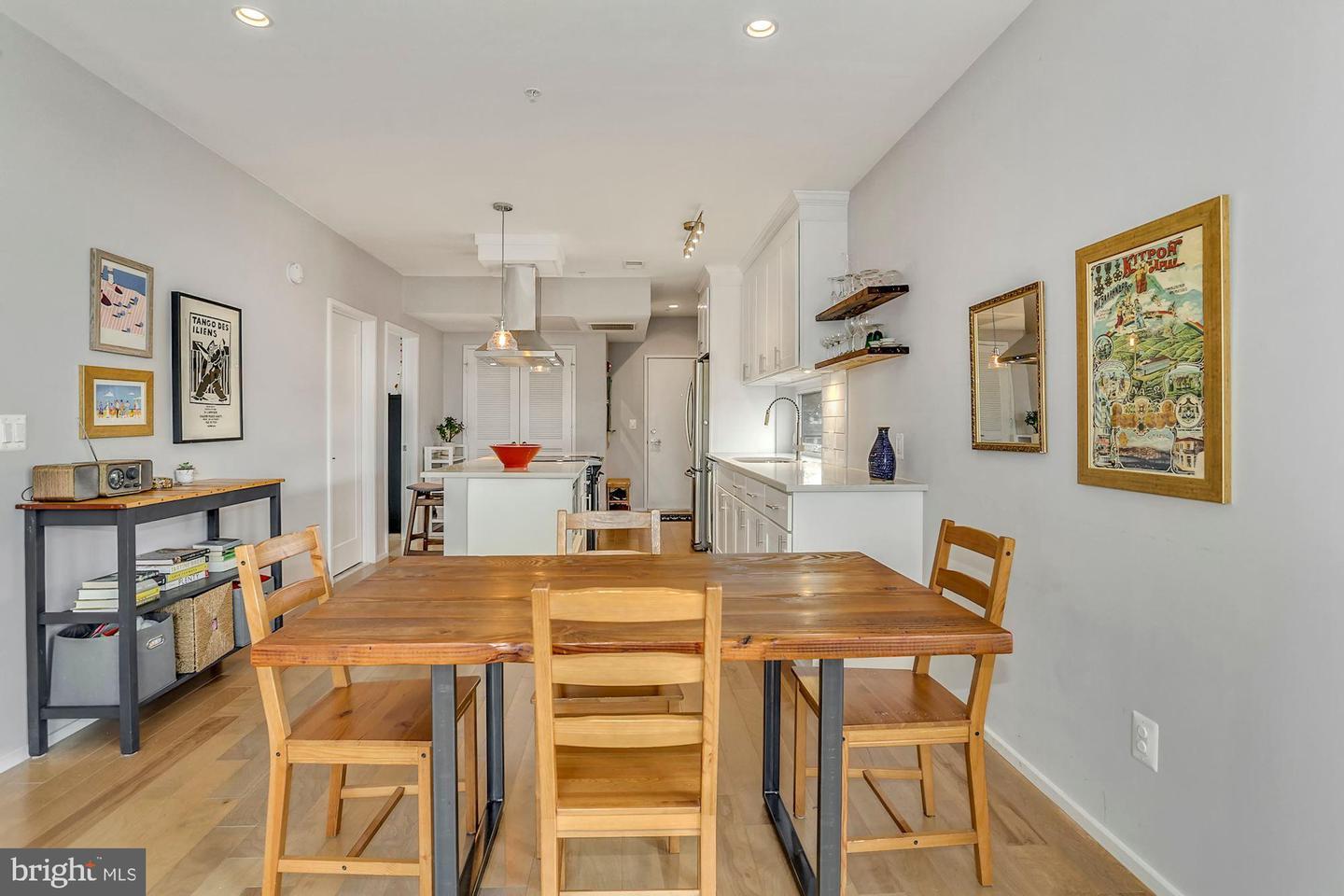 129 Varnum Street Northwest, Unit 6 Washington, DC 20011 - Photo 9 of 25 a dining room with kitchen island a table and chairs
