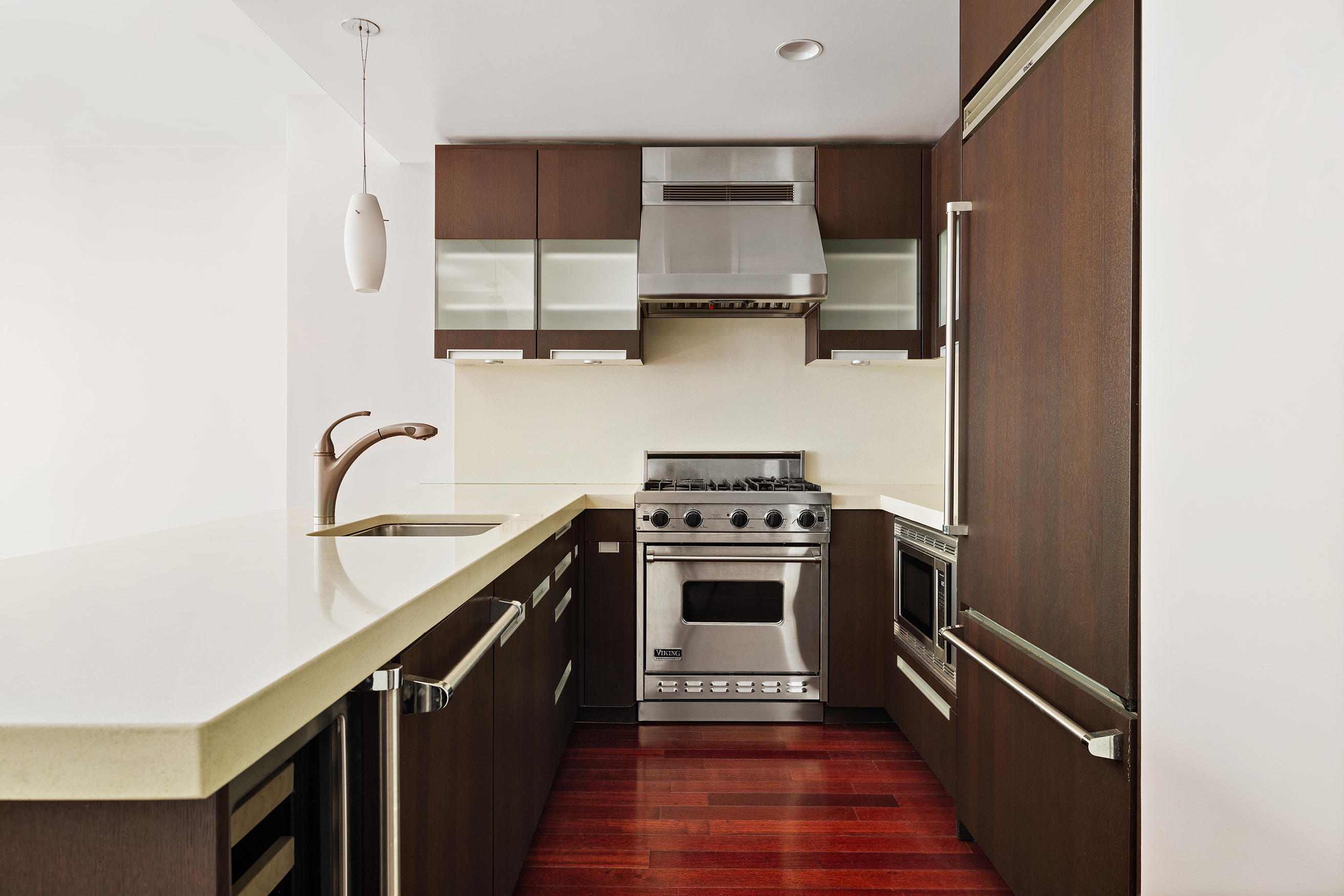 125 West 21st Street, Unit 5B Manhattan, NY 10011 - Photo 5 of 15 a kitchen with stainless steel appliances a sink stove and refrigerator