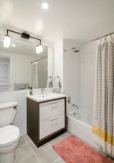 a bathroom with a granite countertop sink toilet and bathtub