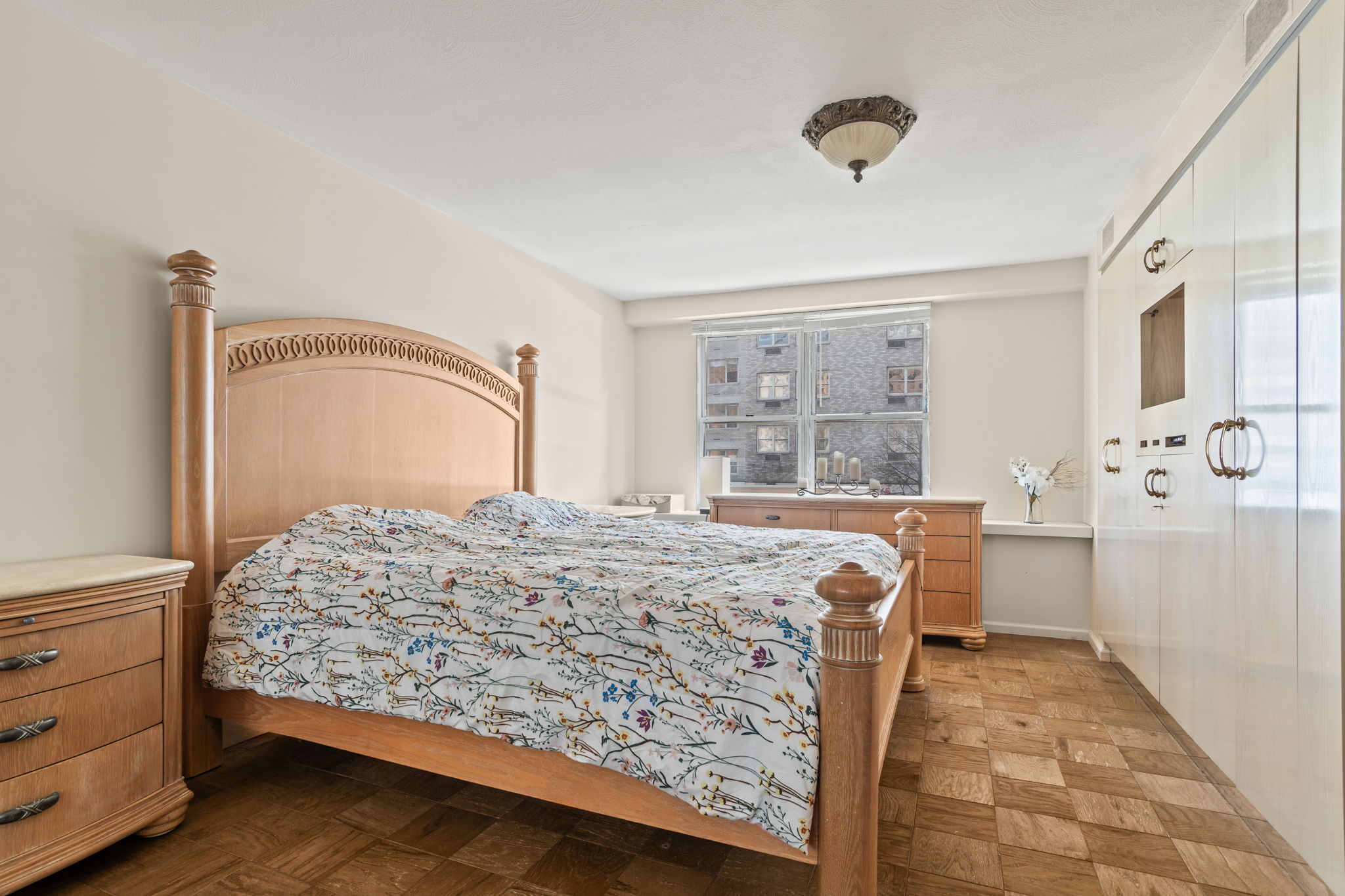 363 East 76th Street, Unit 2F Manhattan, NY 10075 - Photo 10 of 21 a bedroom with a bed and a large window