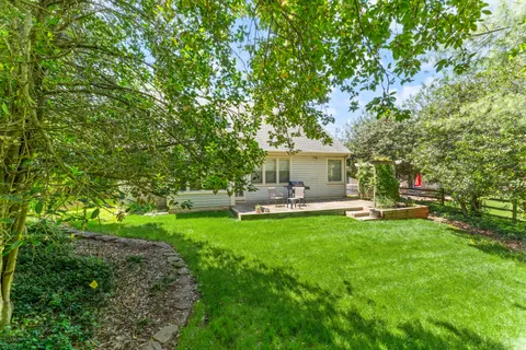 a front view of a house with yard patio and green space