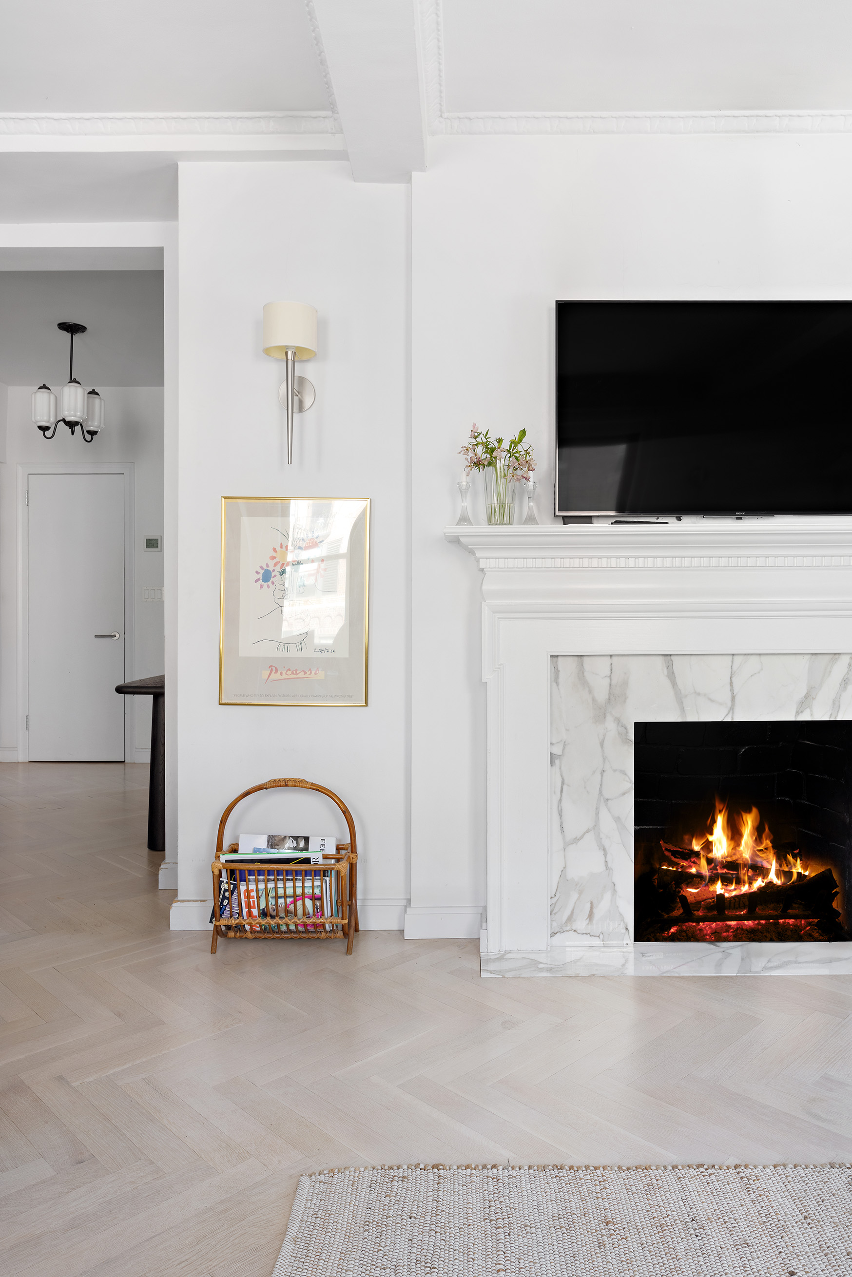 26 East 10th Street, Unit 11G Manhattan, NY 10003 - Photo 7 of 14 a living room with a fireplace and a flat screen tv