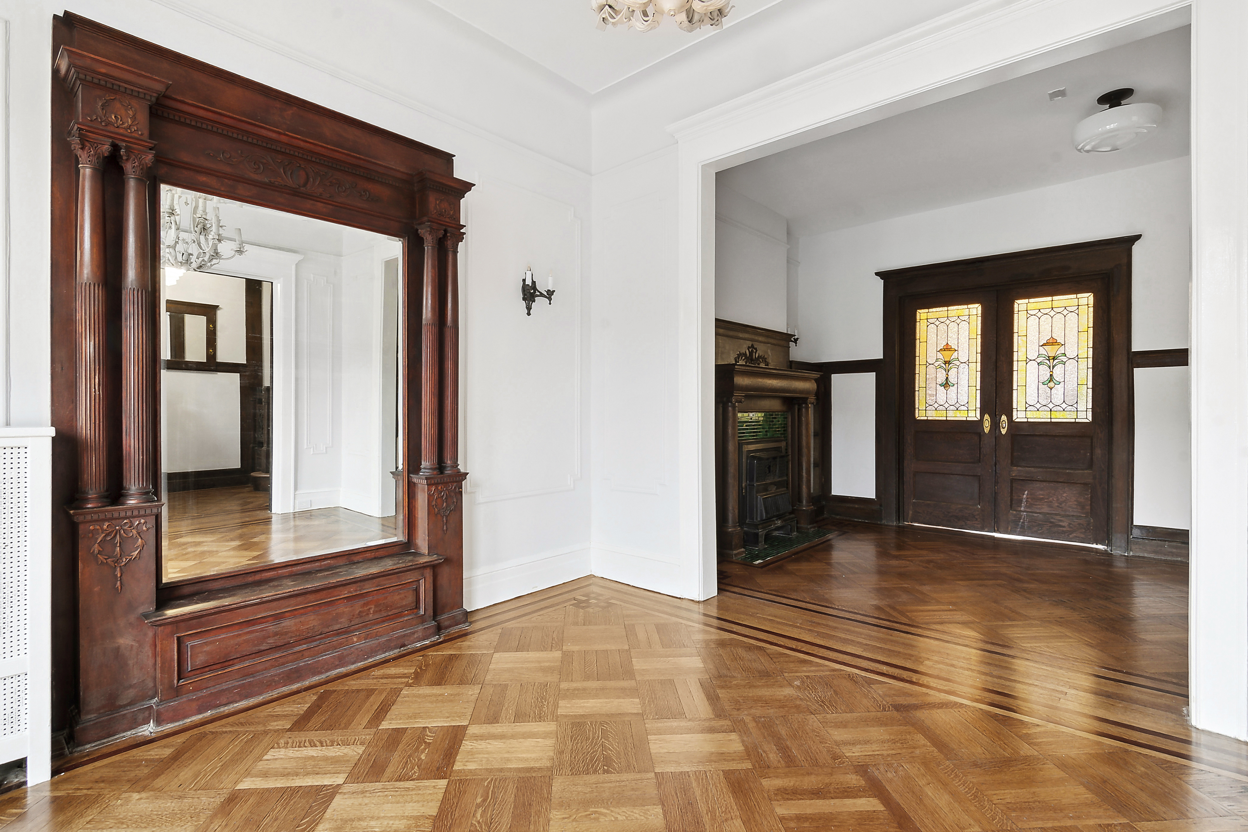 195 Rutland Road Brooklyn, NY 11225 - Photo 6 of 21 a view of a hallway with wooden floor and a living room