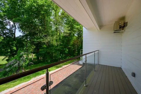 a view of balcony with wooden floor