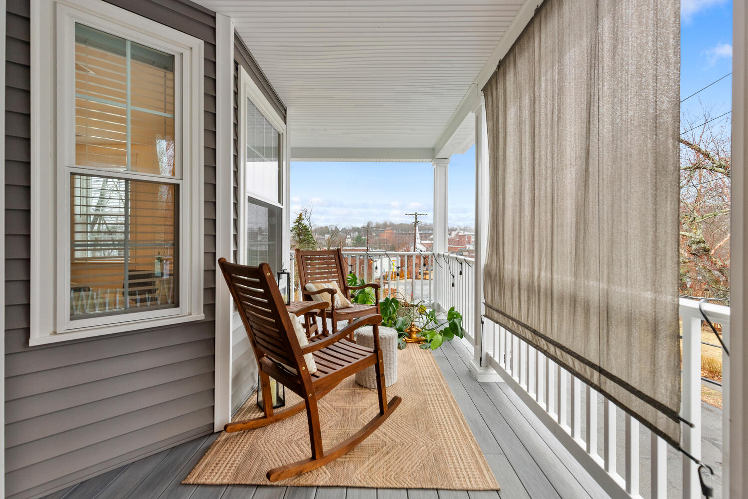 1 Maple Street, Unit 1 Maynard, MA 01754 - Photo 23 of 42 a view of a balcony with furniture and wooden floor