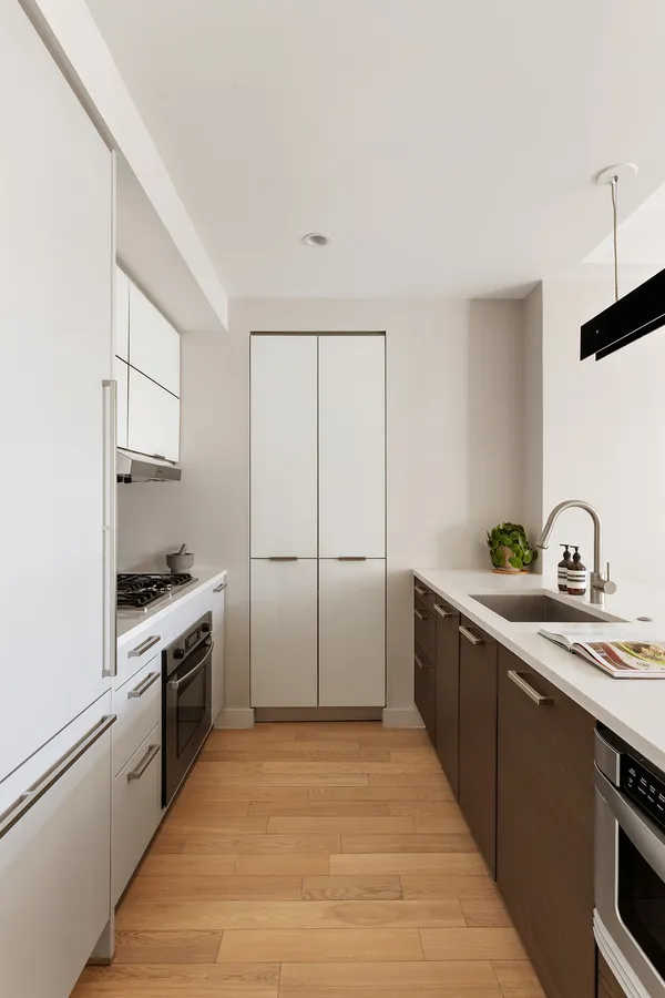 a kitchen with a sink cabinets and stainless steel appliances