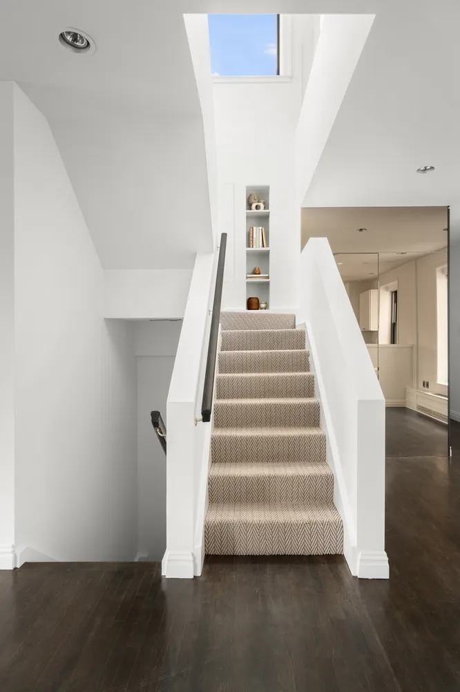 a view of entryway and hall with wooden floor