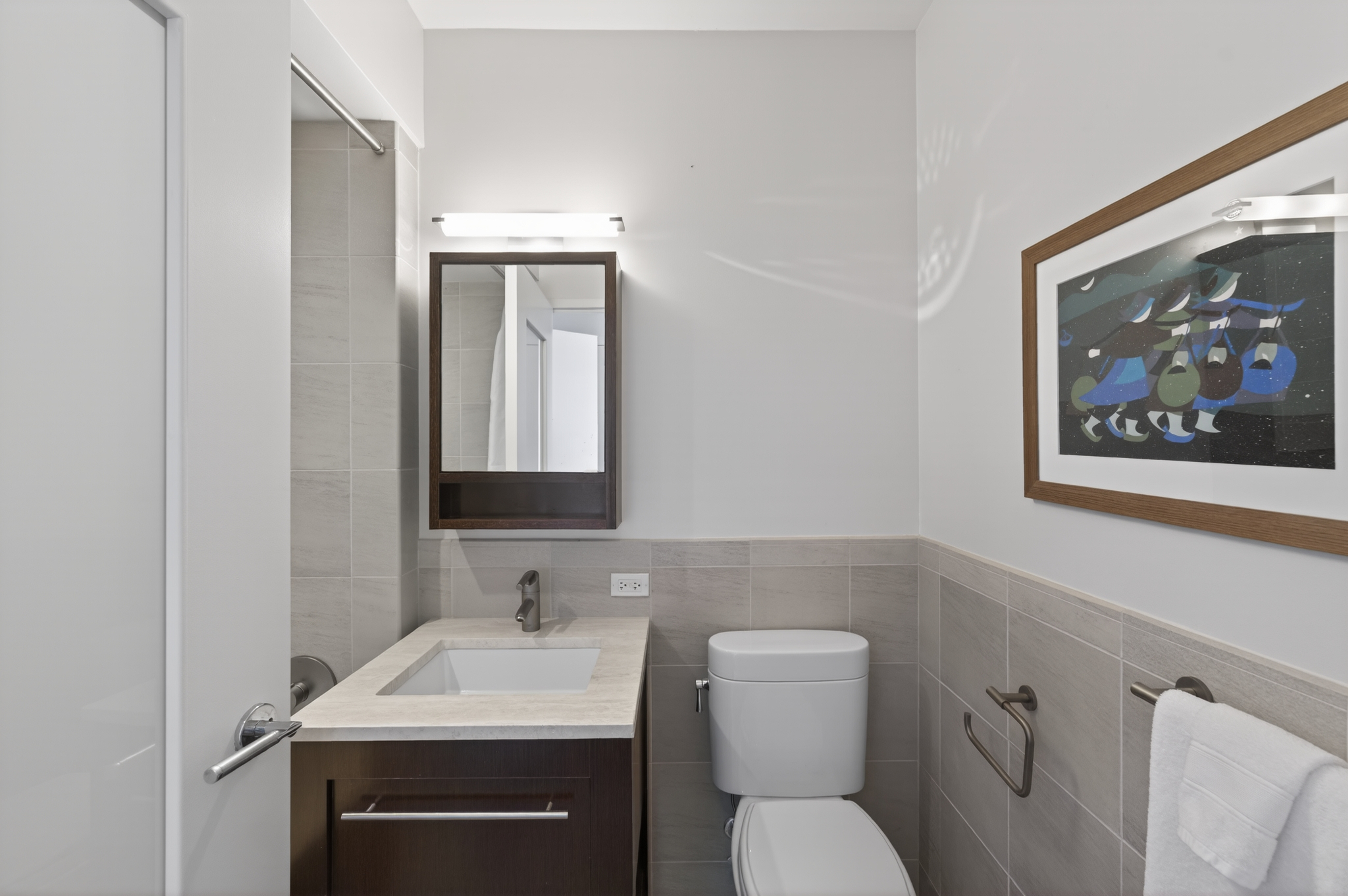 101 West 24th Street, Unit 36C Manhattan, NY 10011 - Photo 15 of 27 a bathroom with a toilet sink and mirror