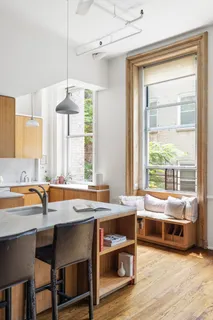 a room with a table chairs and a window