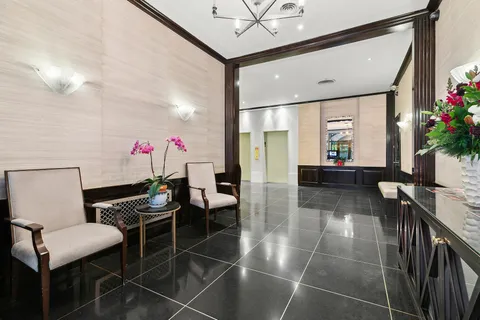 a lobby with furniture and flowers