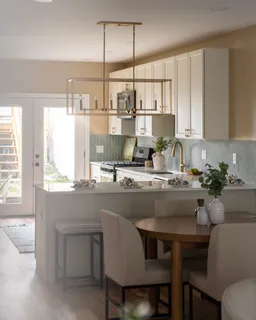 a kitchen with stainless steel appliances granite countertop a refrigerator sink and stove