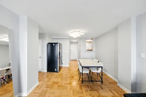 a view of a room with furniture and wooden floor