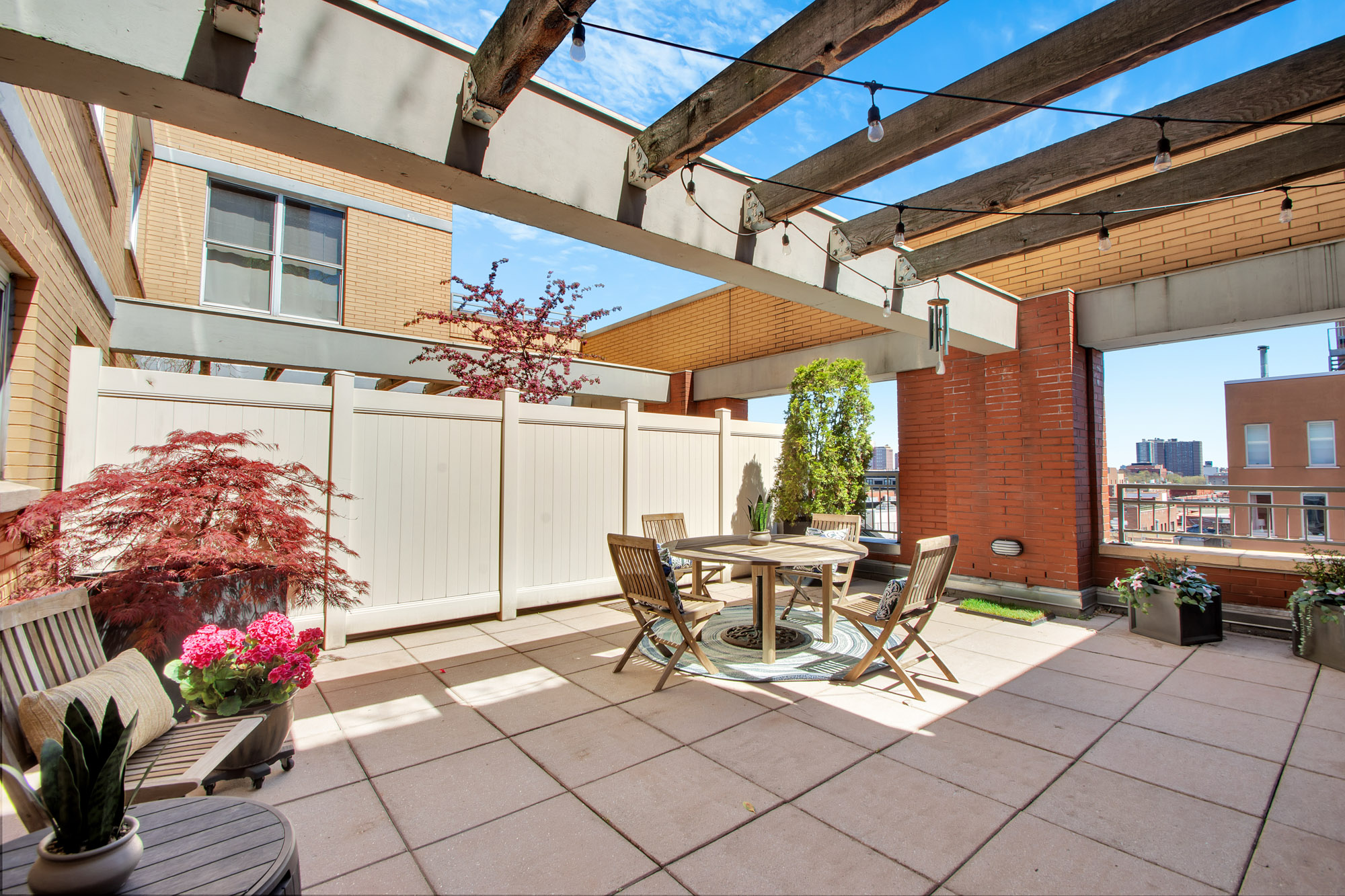301 West 118th Street, Unit 10G Manhattan, NY 10026 - Photo 7 of 17 a view of a patio with a table and chairs and potted plants