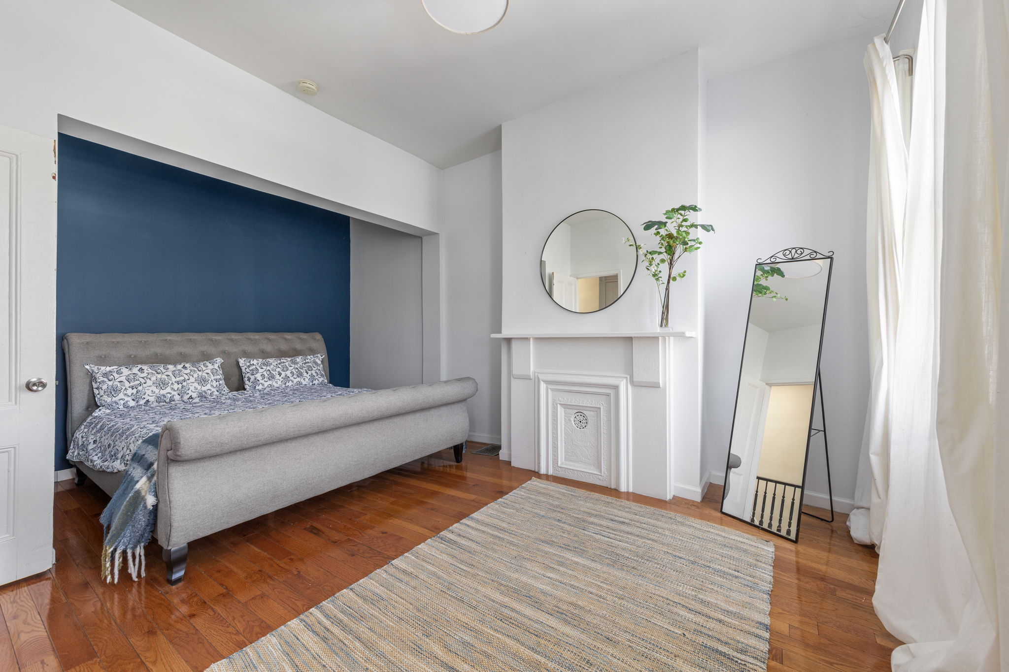 1218 Saint Marks Avenue Brooklyn, NY 11213 - Photo 11 of 42 a living room with a bed furniture and a fireplace