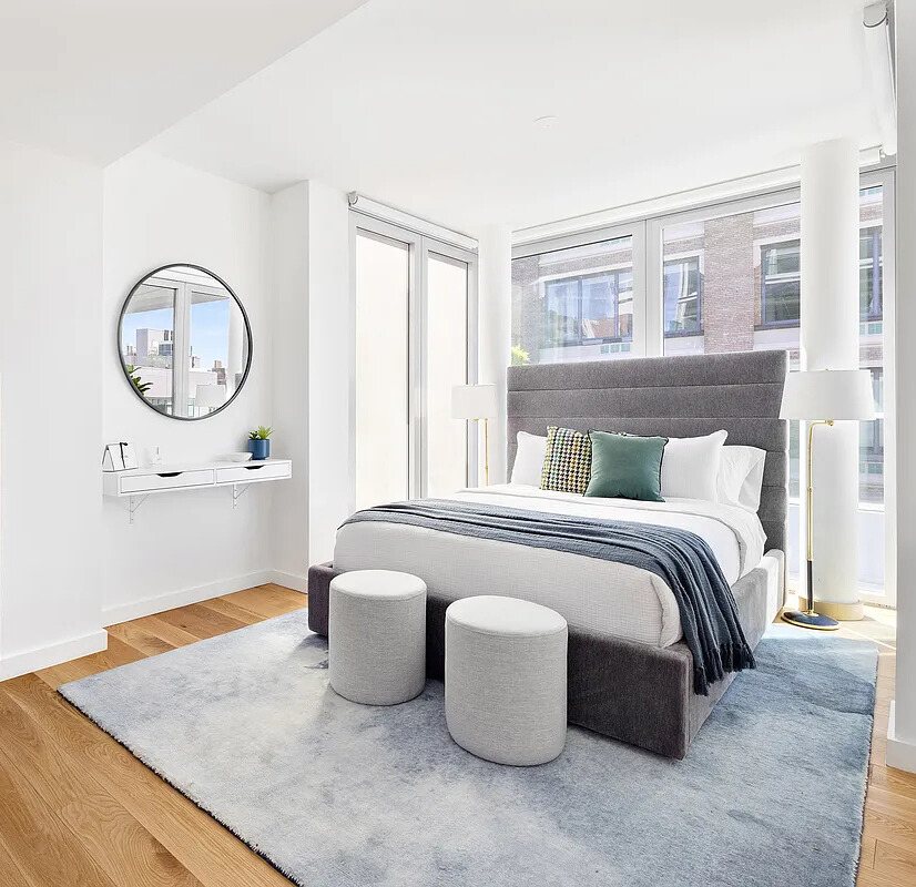 547 West 47th Street, Unit 807 Manhattan, NY 10036 - Photo 4 of 13 a living room with a bed furniture and a window