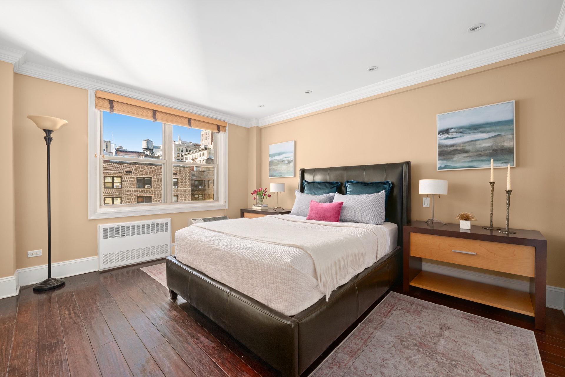 40 East 9th Street, Unit 6M Manhattan, NY 10003 - Photo 12 of 22 a large bed sitting in a bedroom next to a window