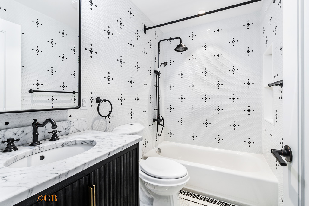 221 Gates Avenue, Unit 2 Brooklyn, NY 11238 - Photo 5 of 7 a bathroom with a granite countertop sink a toilet and a bathtub