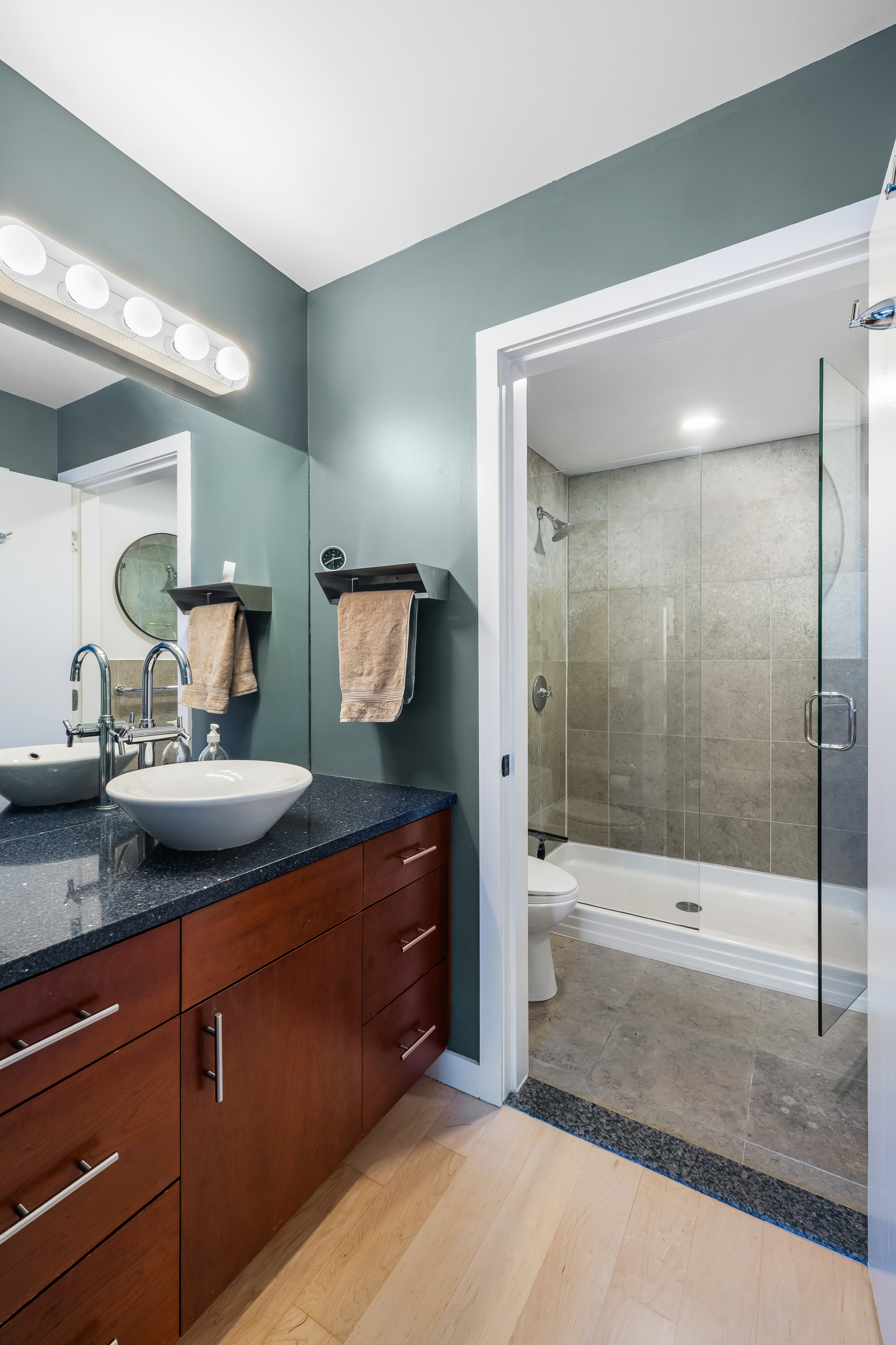 20 Tiffany Place, Unit 6N Brooklyn, NY 11231 - Photo 7 of 12 a bathroom with a sink a mirror and shower