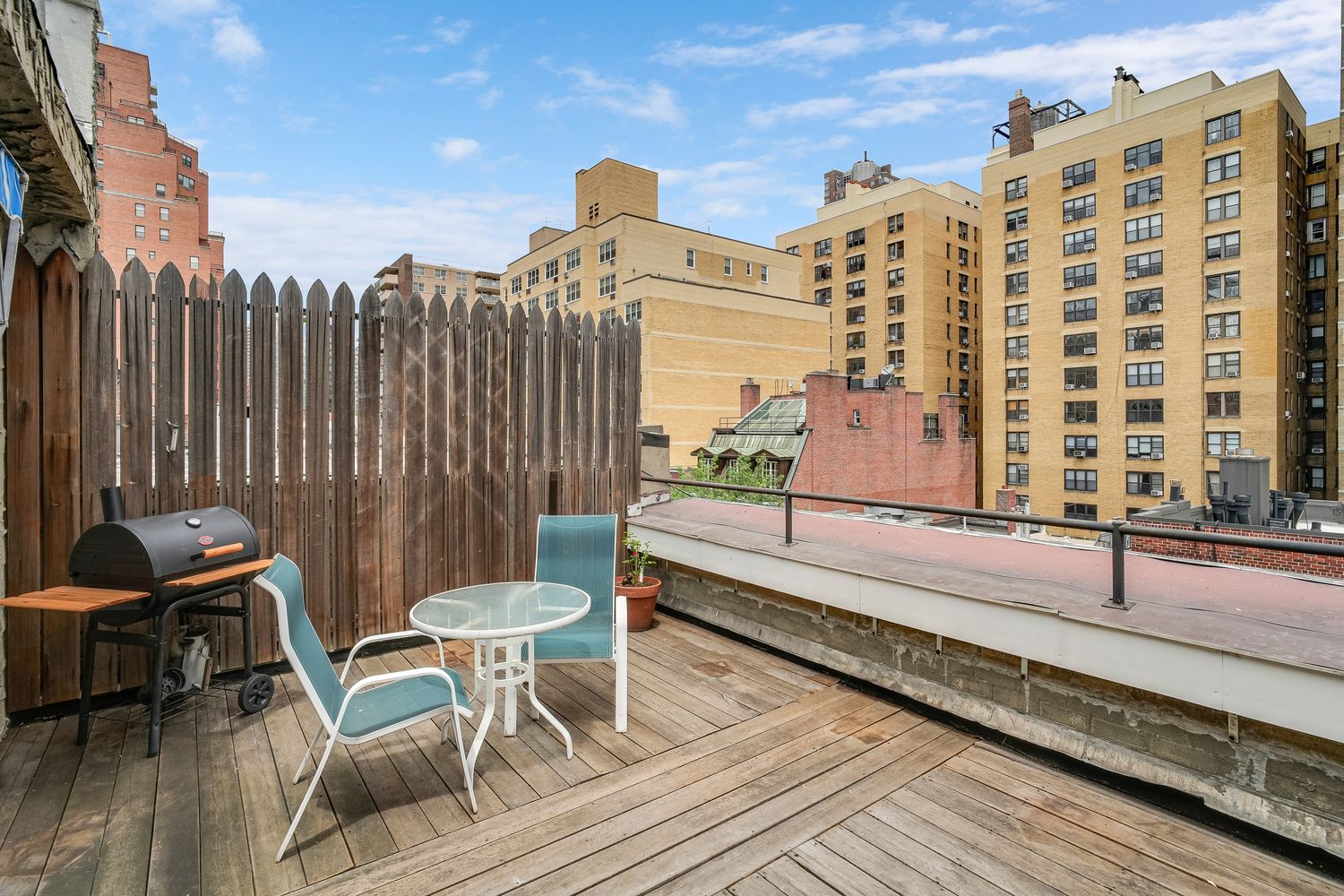 a balcony with table and chairs