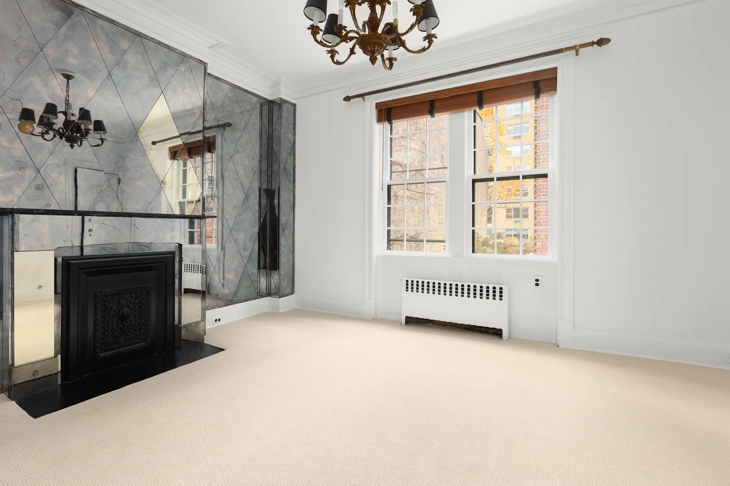 an empty room with windows and fireplace