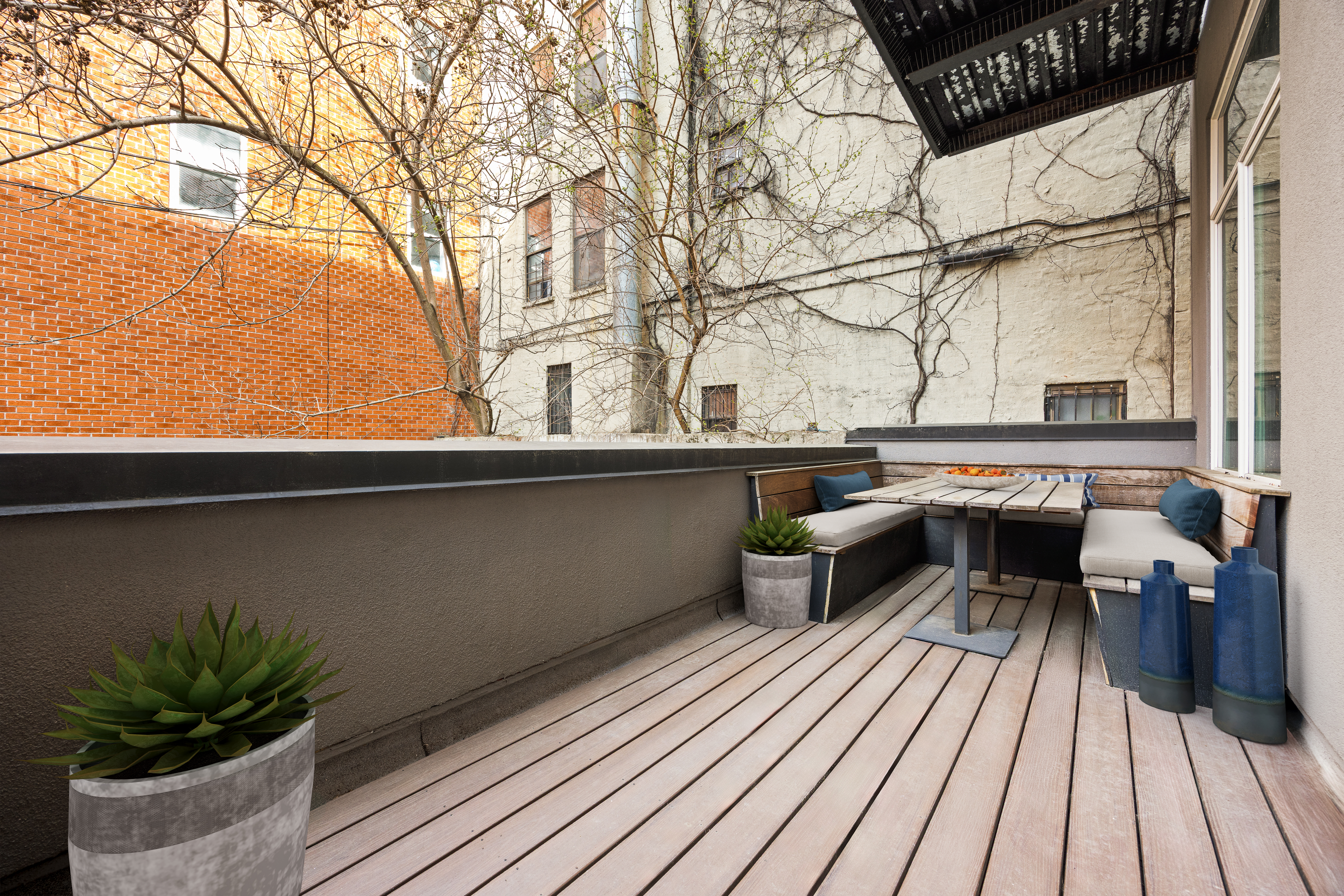 622 Grand Avenue, Unit 103 Brooklyn, NY 11238 - Photo 6 of 19 a balcony with wooden floor table and chairs