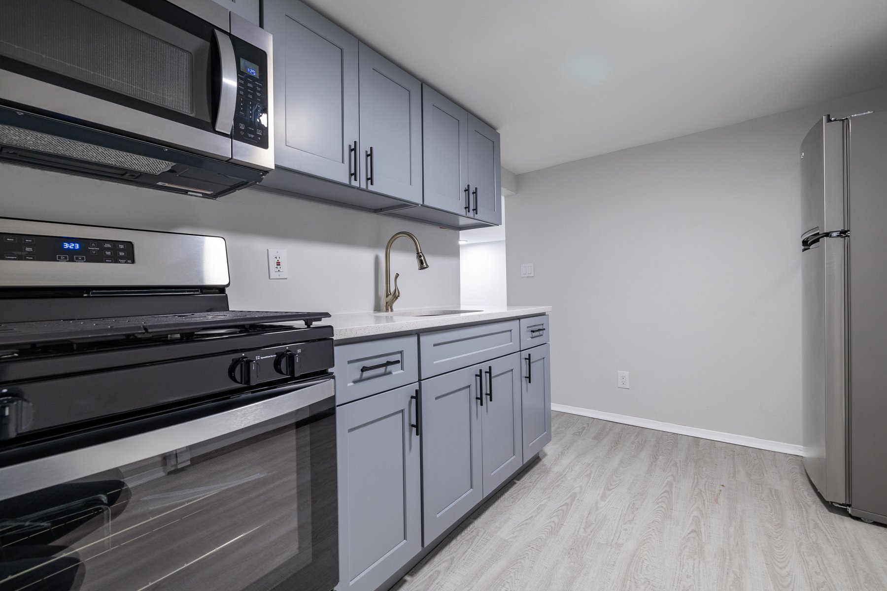 13-03 Brunswick Avenue Queens, NY 11691 - Photo 21 of 27 a kitchen with stainless steel appliances granite countertop a stove and a microwave