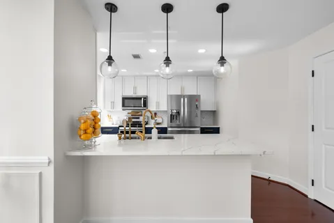 a kitchen with stainless steel appliances a stove microwave and sink