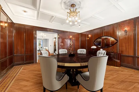 a dining room with furniture and wooden floor