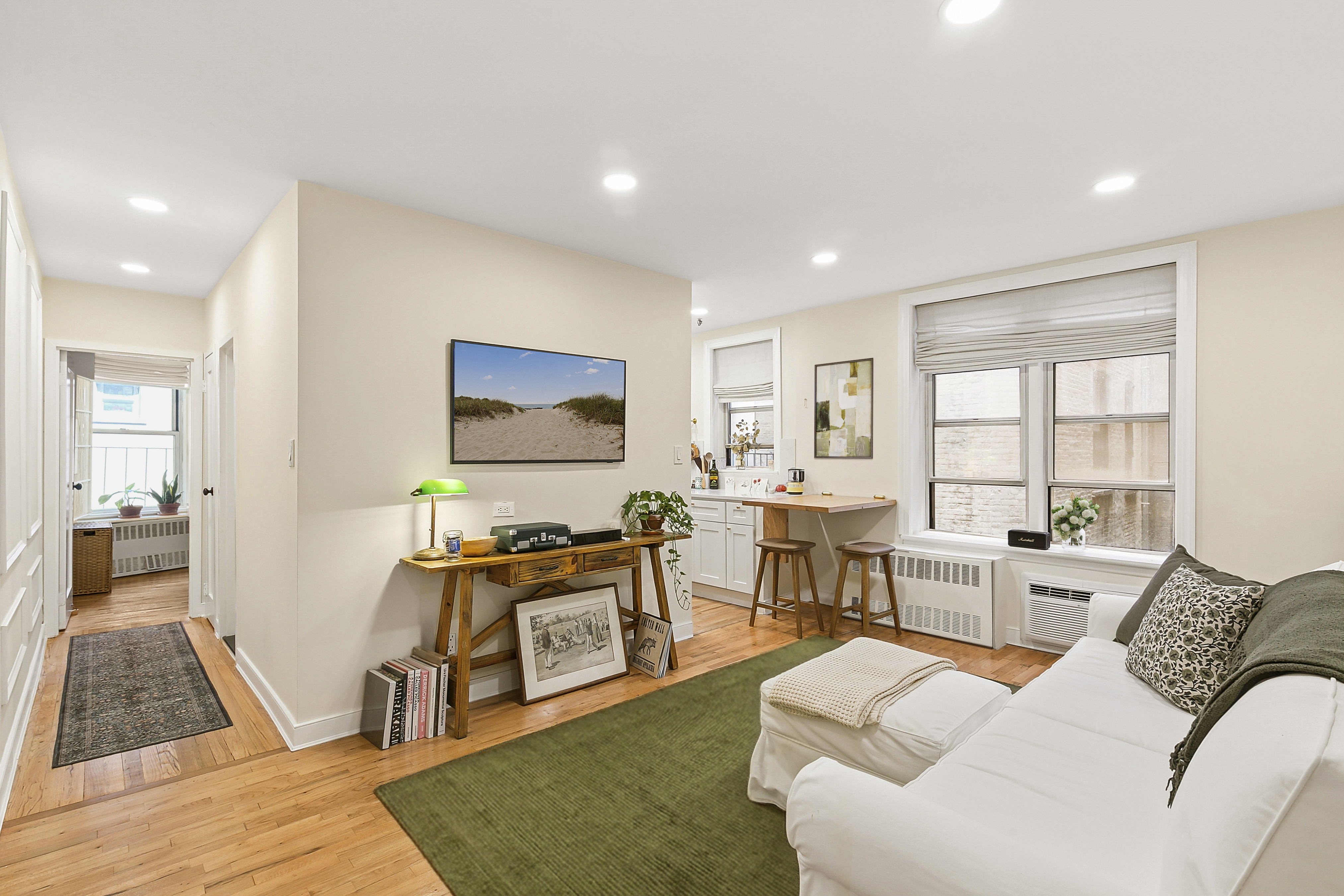 a living room with furniture wooden floor and a flat screen tv
