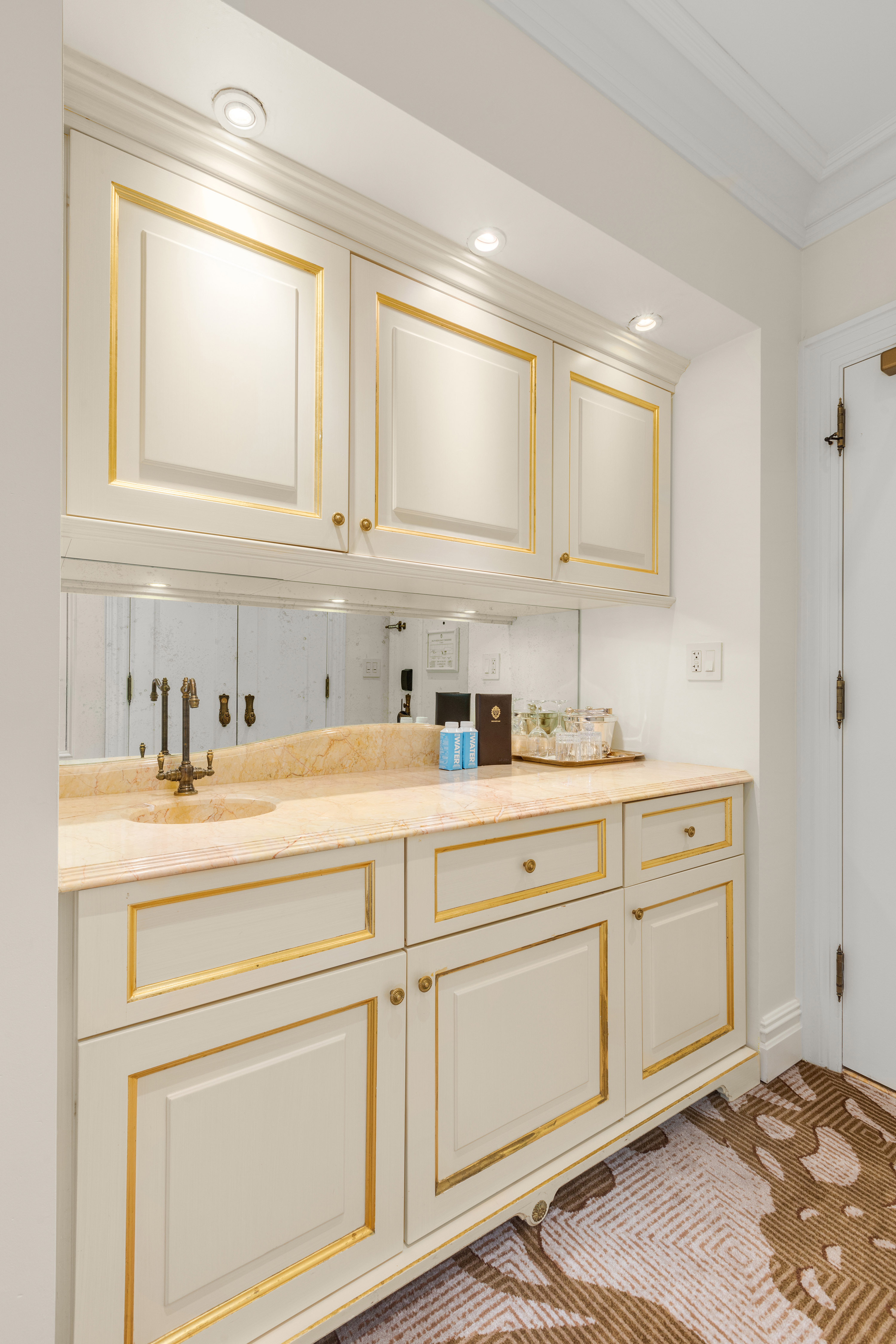 1 Central Park South, Unit 1336 Manhattan, NY 10019 - Photo 5 of 21 a kitchen with white cabinets and sink