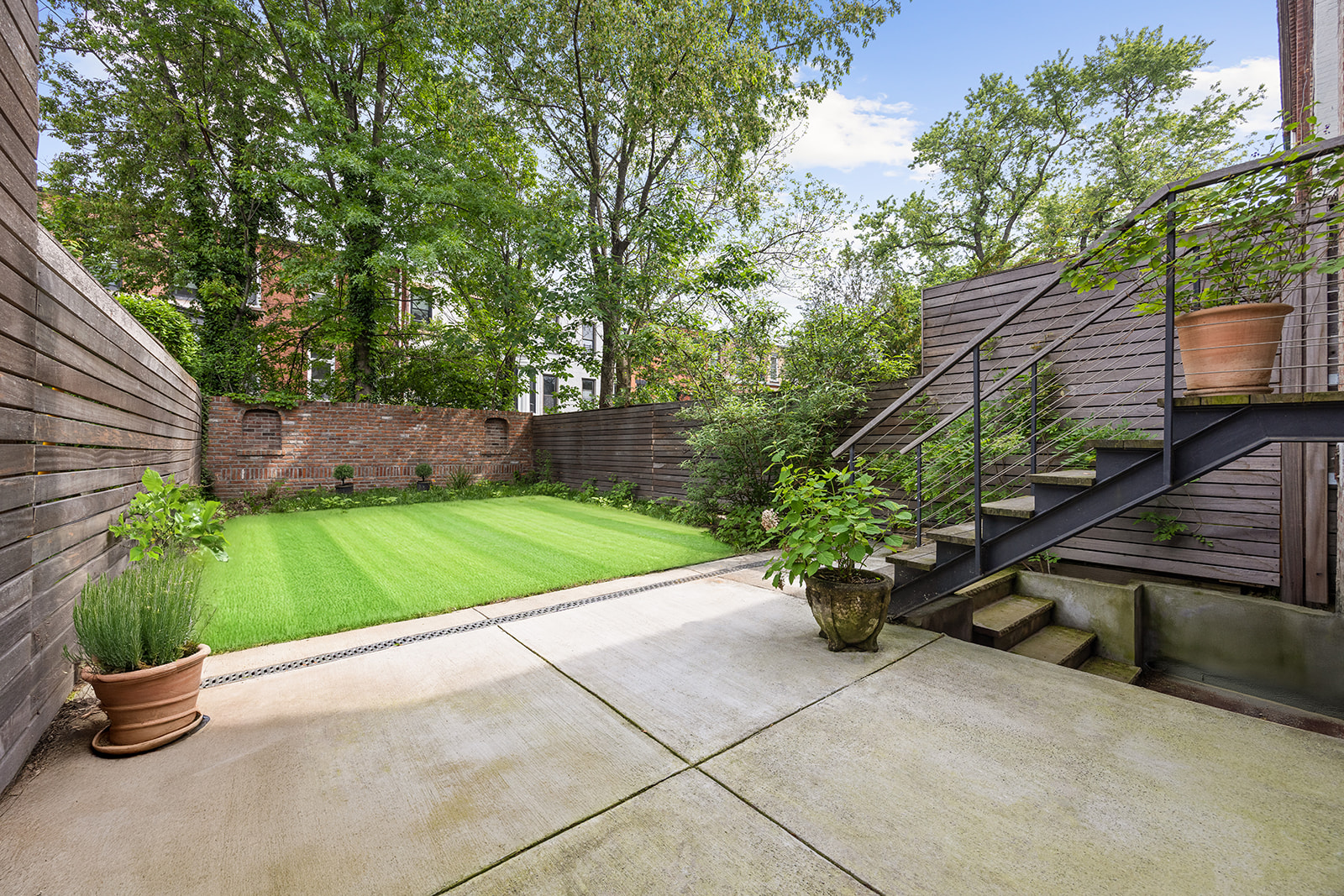 125 Rutland Road Brooklyn, NY 11225 - Photo 17 of 22 a view of a backyard with plants and a garden