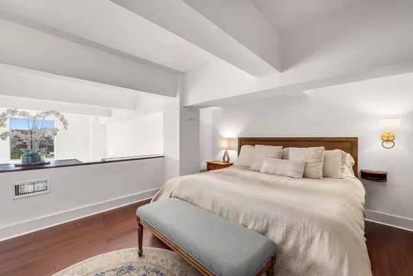 a large white bed in a white room