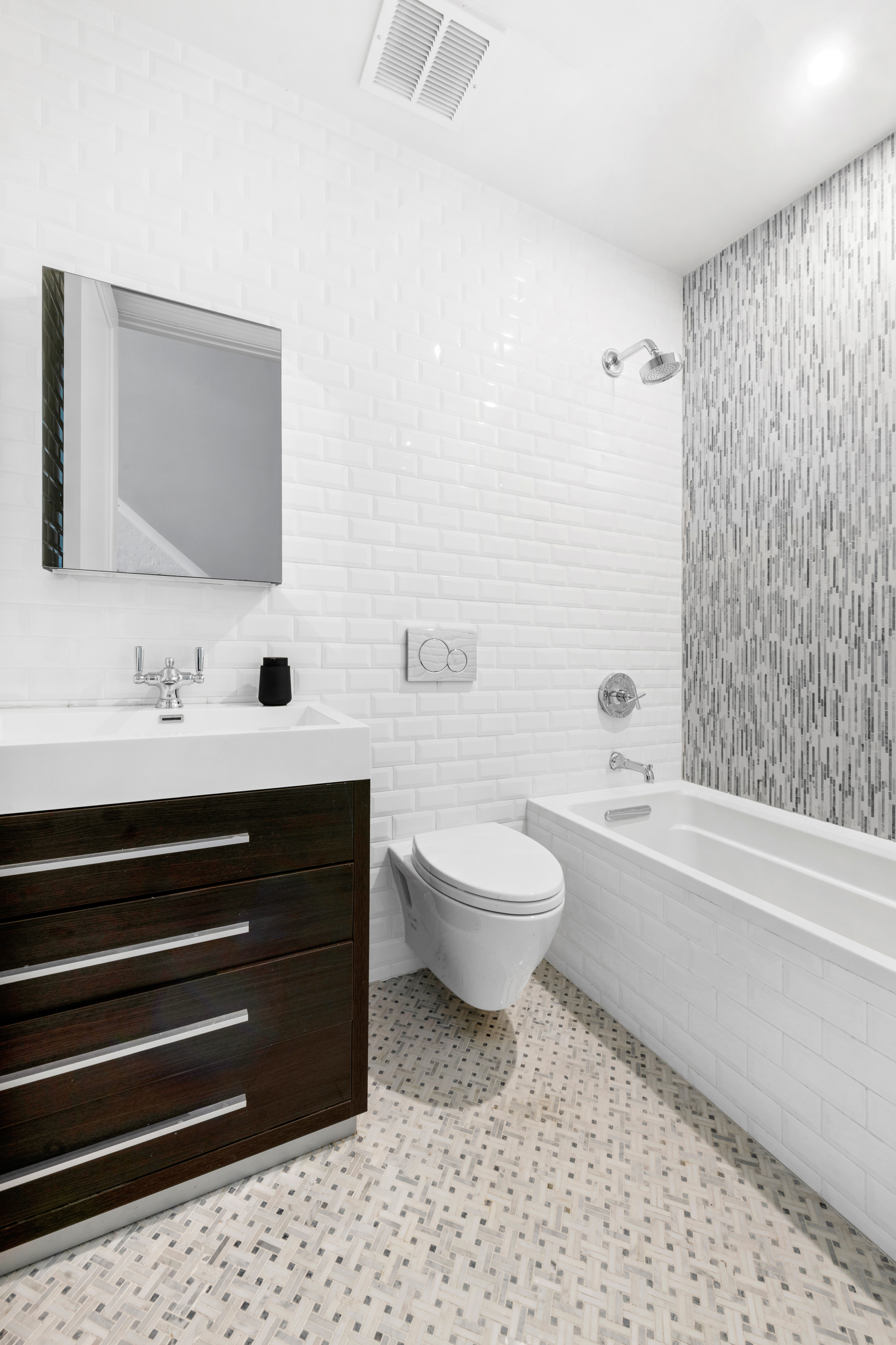 129 West 131st Street, Unit 1 Manhattan, NY 10027 - Photo 11 of 15 a bathroom with a sink a toilet and shower