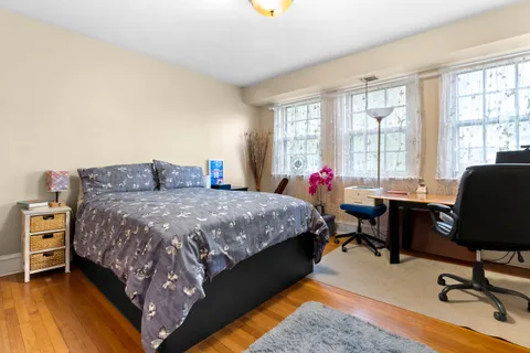 a bedroom with a bed and a desk