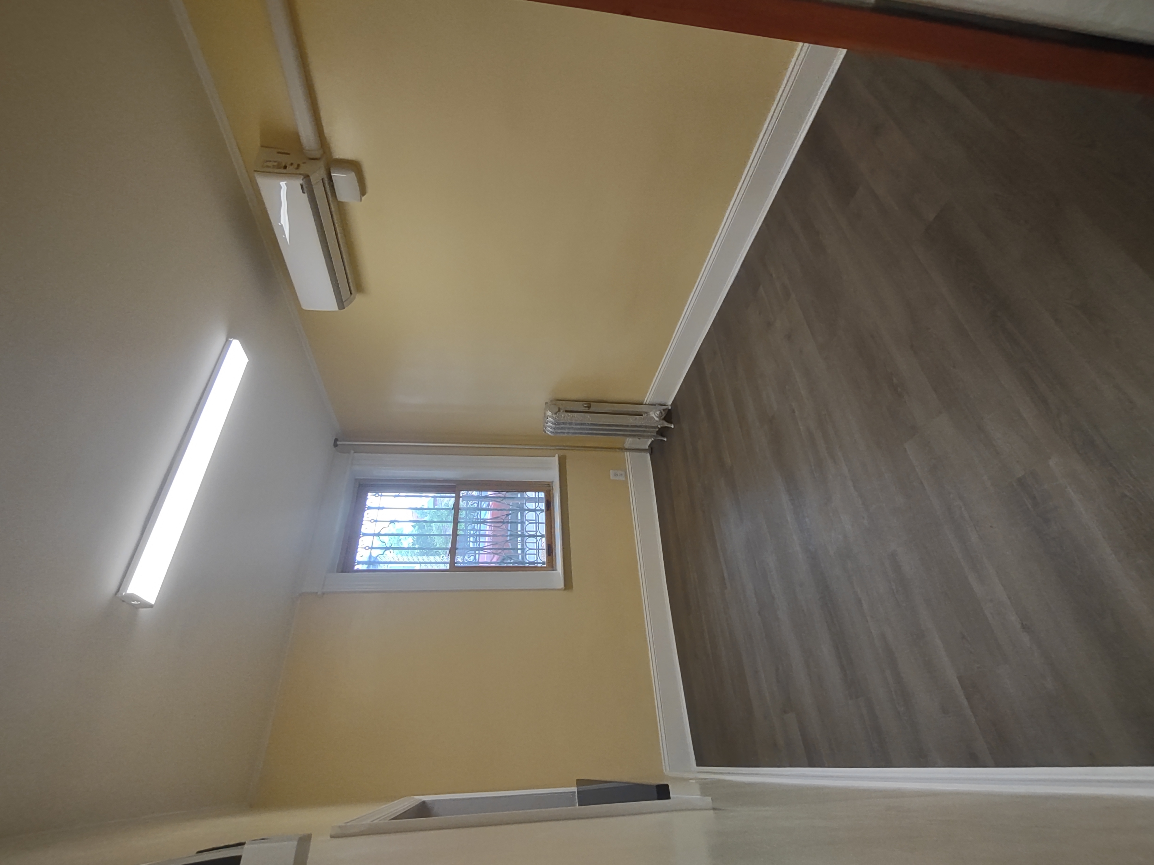 175 Fenimore Street Brooklyn, NY 11225 - Photo 5 of 11 an empty room with wooden floor and windows