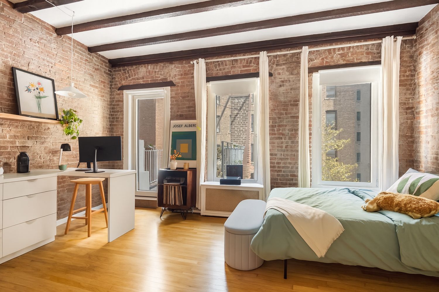 a bedroom with a large bed and a flat screen tv