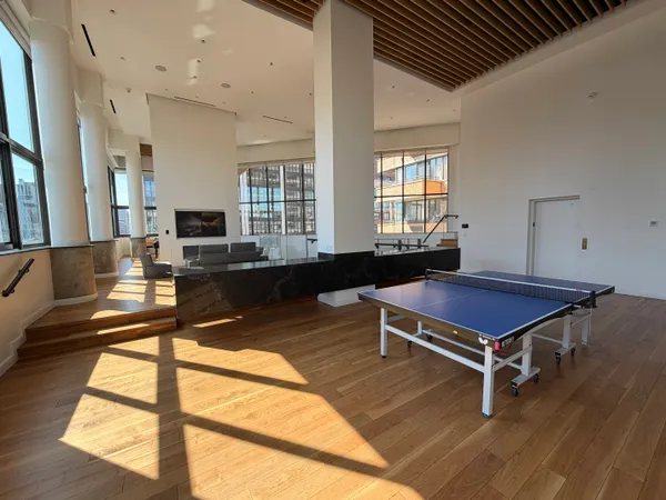 a living room with pool table and windows